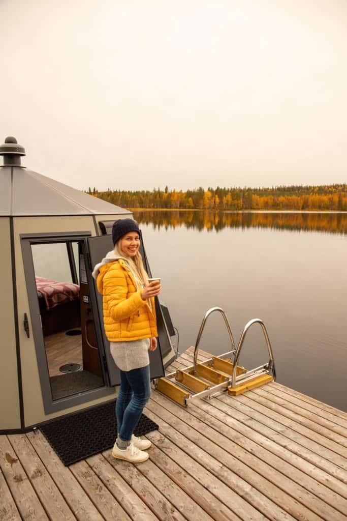 woman standing on the lake dock near a glass igloo
