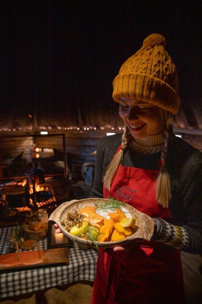 Woman holding a plate of homemade Finnish food