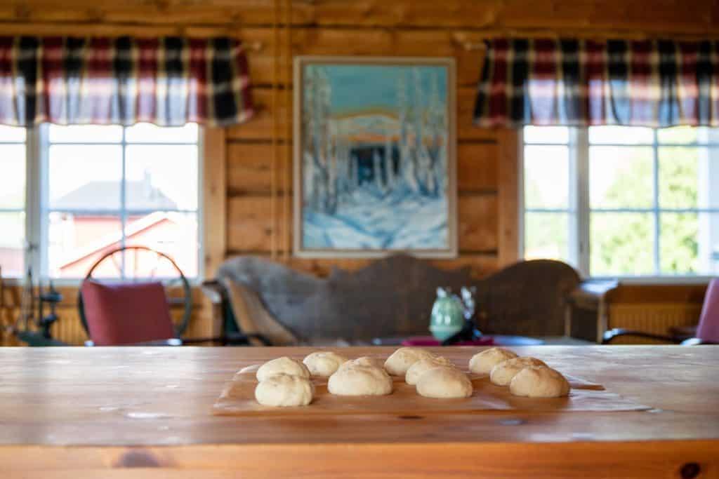 uncooked cinnamon bun's dough sitting on a table