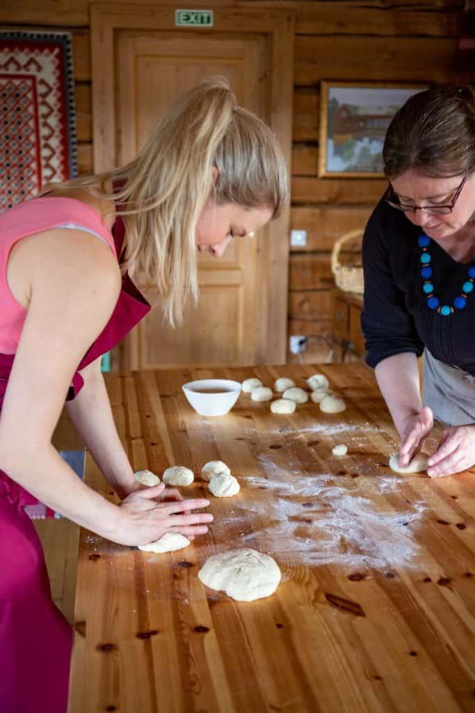 2 women preparing dough for baking