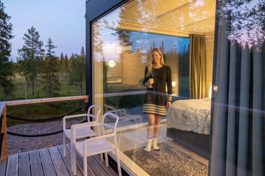 Woman looking out from her glass cabin