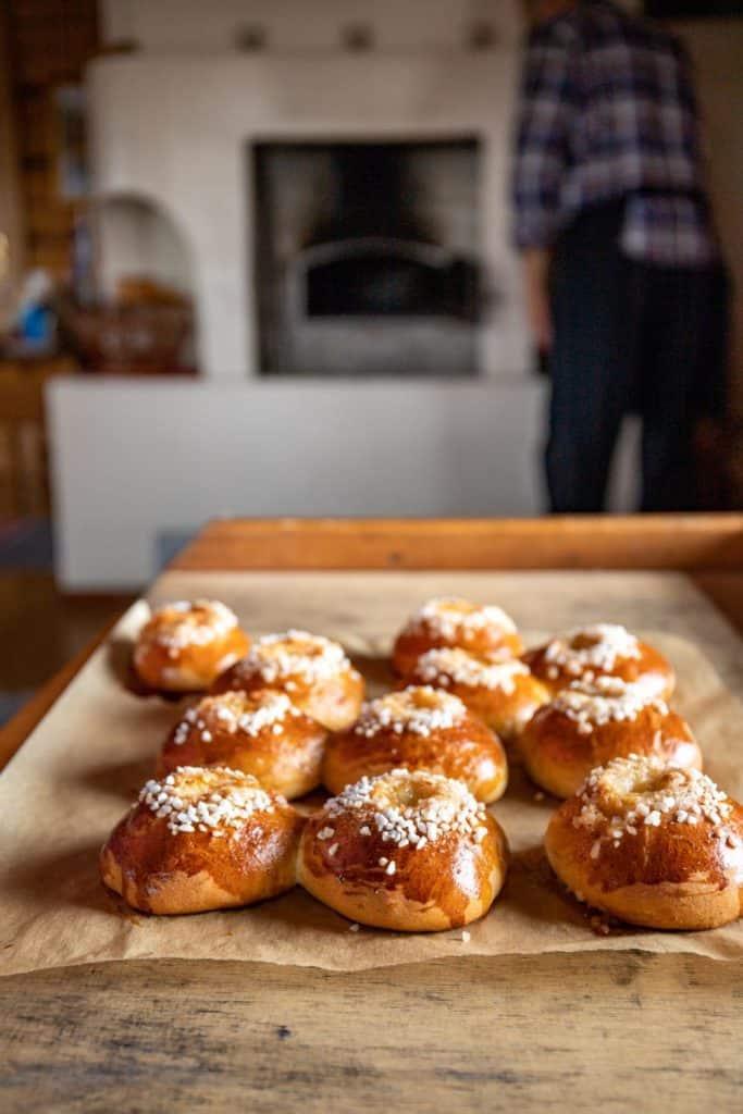 several cinnamon buns presented on a wooden table