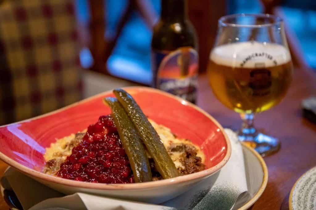 pickles, mashed potatoes, and jam in a bowl at a restaurant