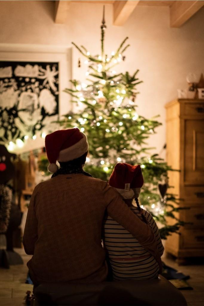 loving family staring at shiny christmas tree